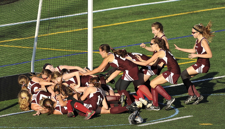 Gabe Souza/Staff Photographer Foxcroft Academy celebrates its victory over NYA in the Class C field hockey championship at Yarmouth High School Saturday, November 2, 2013.