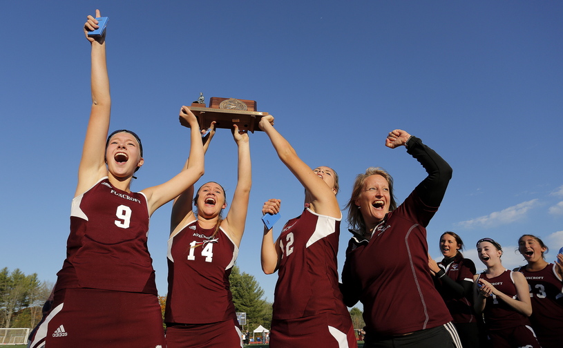 Gabe Souza/Staff Photographer Foxcroft's Amber Anderson, Mackenzie Coiley, Emily Higgins, and coach Stephanie Smith celebrate their victory over NYA in the Class C field hockey championship at Yarmouth High School Saturday, November 2, 2013.
