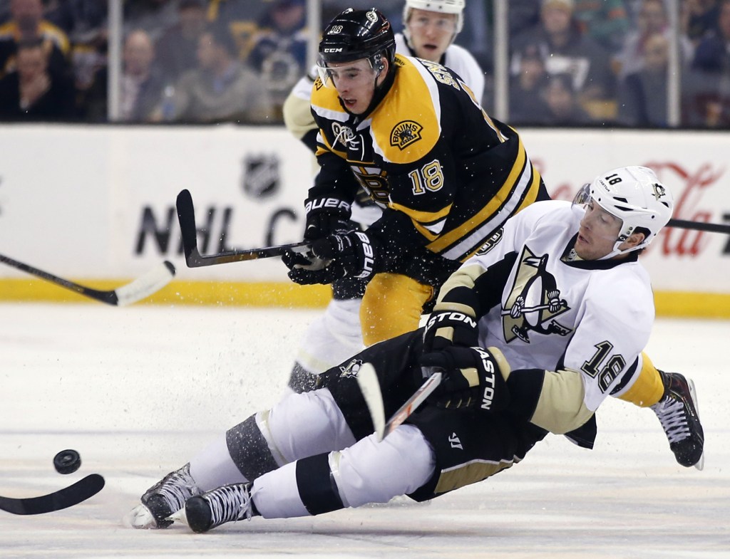 Penguins left wing James Neal (18) loses his edge while chasing the puck against Bruins right wing Reilly Smith (18) in the second period in Boston on Monday.