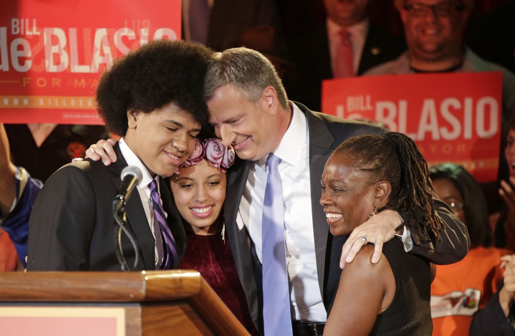 New York mayoral candidate Bill de Blasio embraces his son Dante, left, daughter Chiara, second from left, and wife Chirlane McCray. Bill de Blasio is apparently the first white politician in U.S. history elected to a major office with a black spouse by his side.