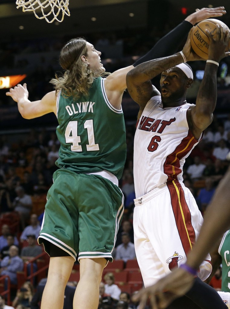 Miami Heat’s LeBron James (6) shoots as Boston Celtics’ Kelly Olynyk (41) defends during the first half of an NBA basketball game Saturday, Nov. 9, 2013, in Miami.
