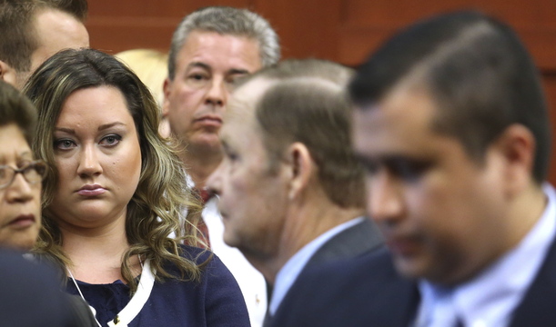 George Zimmerman’s wife, Shellie, watches her husband leave the courtroom during his murder trial in July. Since his acquittal, he has had several brushes with law enforcement.