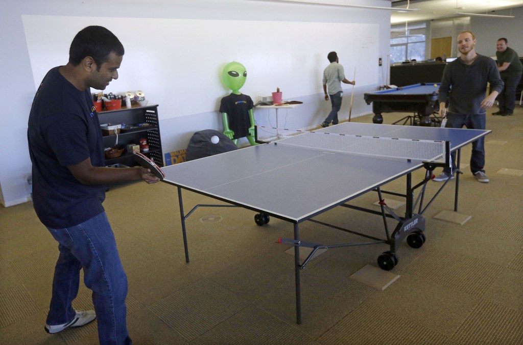 Pranay Kuruvilla, left, senior software engineer for Walmartlabs, plays ping pong with Benjamin Pellow, principal software engineer, at the Walmart.com office in San Bruno, Calif. Wal-Mart has embraced a Silicon Valley startup feel with its San Bruno offices – in stark contrast to the company’s rambling brick headquarters with its frayed carpets and ’70s-style paneling.