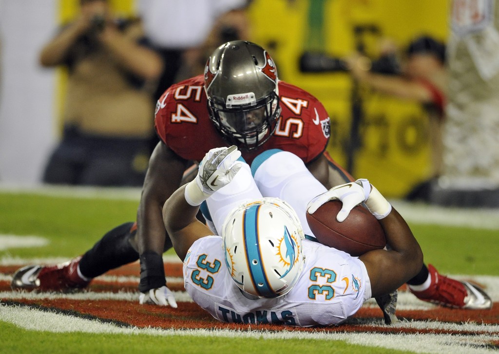Tampa Bay Buccaneers outside linebacker Lavonte David (54) tackles Miami Dolphins running back Daniel Thomas in the end zone for a safety during the second quarter of an NFL football game Monday in Tampa, Fla.