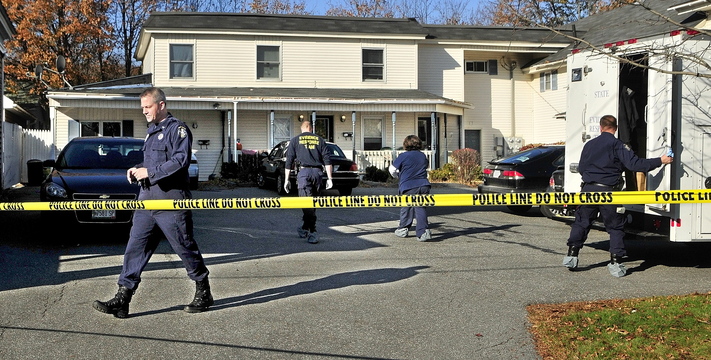 Investigators work at the scene of a killing Thursday at 32 Crosby St. in Augusta.
