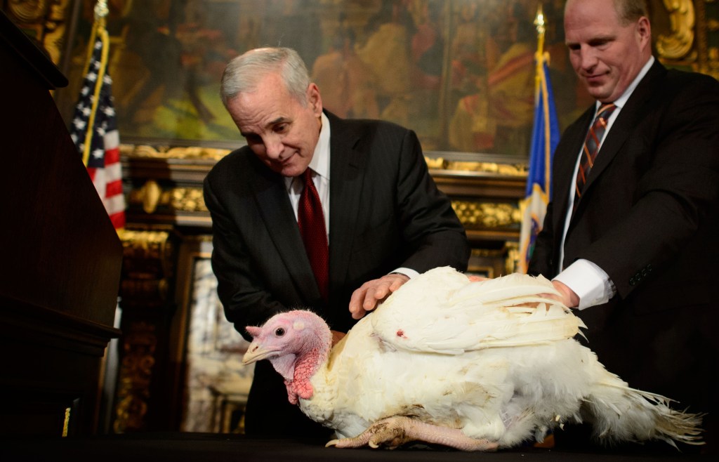 Minnesota Gov. Mark Dayton, center, kicks off Thanksgiving week in Minnesota by ordering a brief stay of execution for a turkey at the state Capitol in Minneapolis AP Photo