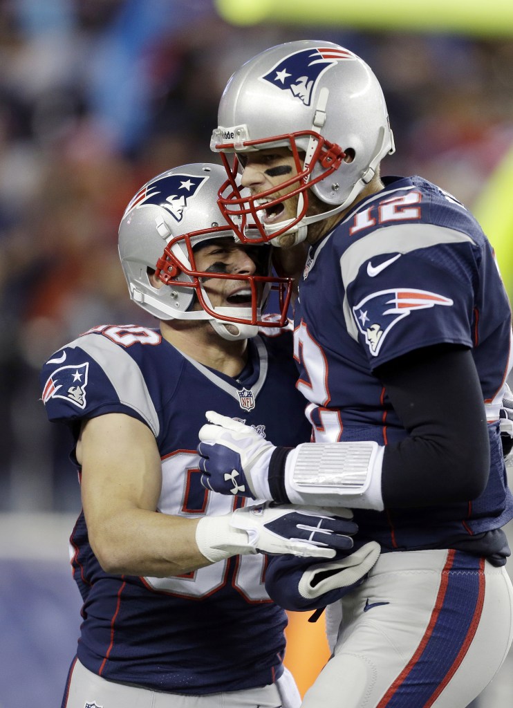 Receiver Danny Amendola, left, is congratulated by quarterback Tom Brady after catching his first touchdown pass as a New England Patriot during Sunday’s rout of the Pittsburgh Steelers.