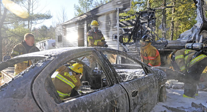 About 15 firefighters responded to a camper fire on Beach Road in South China on Tuesday morning. Laura Ellis escaped injury after her car caught fire and spread to the trailer she was staying in.