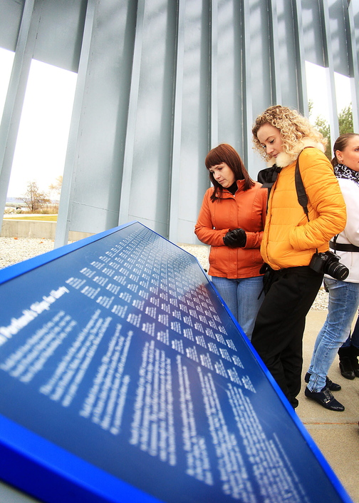 Vera Pigina, left, and Anna Ilina, both members of a visiting Russian delegation from Portland’s sister city of Archangel, read the names of the ships built by the emergency shipyards between 1941 and 1945 while visiting the Liberty Ship Memorial at Bug Light Park in South Portland on Sunday.