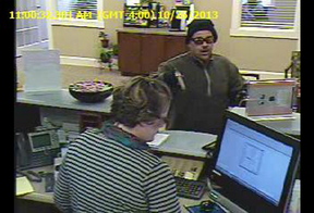 This image taken from video shows a man robbing a teller at the Ocean Communities Federal Credit Union in Sanford on Oct. 26. Philip Gage of Somersworth, N.H., was charged and is also a suspect in four other robberies.