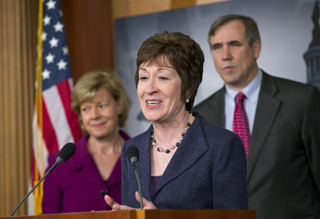Proponent Sen. Susan Collins, R-Maine, flanked by Sen. Tammy Baldwin, D-Wis., left, and Sen. Jeff Merkley, D-Ore., talks to reporters after the Senate cleared a major hurdle and agreed to proceed to debate on a bill that would prohibit workplace discrimination against gay, bisexual and transgender Americans, at the Capitol in Washington on Monday.