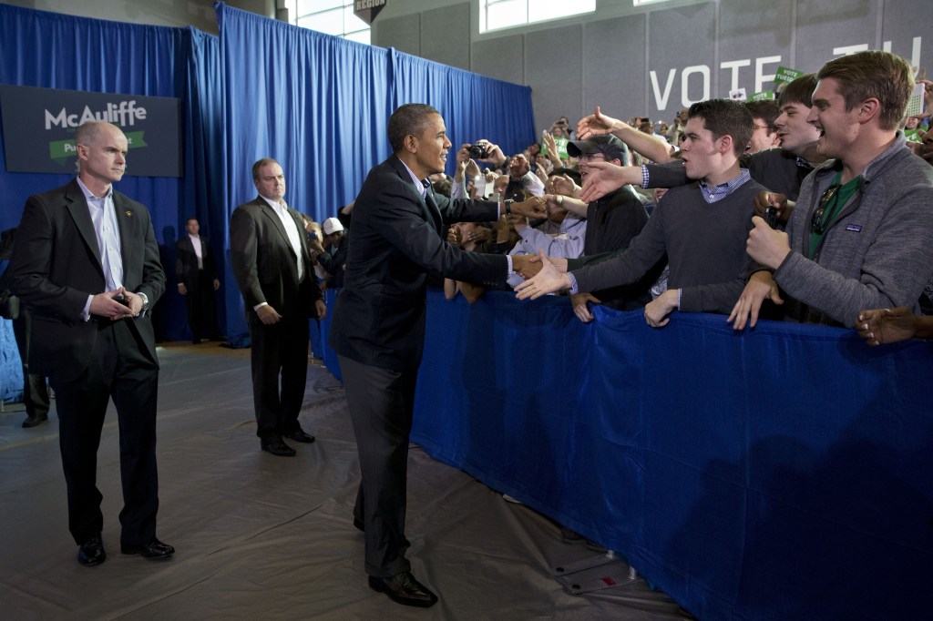 President Barack Obama is greeted by the crowd before speaking at a campaign event for Virginia Democratic gubernatorial candidate Terry McAuliffe at Washington-Lee High School in Arlington, Va. on Sunday, Nov. 3, 2013.