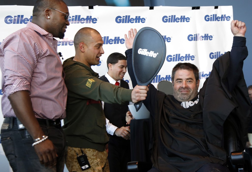 Boston police officer Steve Horgan recreates his famous home run playoff pose as Red Sox players Shane Victorino, center, and David Ortiz watch during Gillette’s $100,000 “shave off” fundraising event for One Fund Boston on Monday.