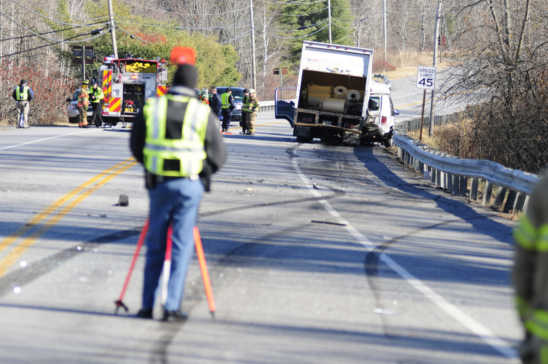A state police accident reconstruction team and emergency crews work at the scene of a collision between a van and a panel truck near intersection of U.S. Route 202 and Royal Street in Winthrop on Thursday.