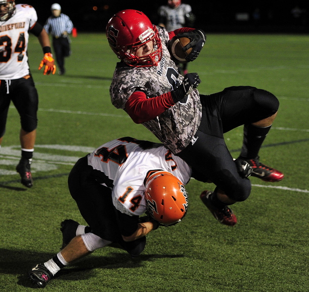 Zach Carriero of Scarborough is brought down by Corey Brown of Biddeford but not before gaining a first down Friday night during their Western Class A quarterfinal. Scarborough will take on top-ranked Bonny Eagle after scoring a 45-19 victory at home.