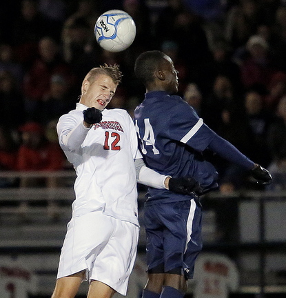 Scarborough’s Wyatt Omsberg, left, challenges Portland’s Jonathan Bobe for possession during the Western Class A final in Scarborough on Wednesday.