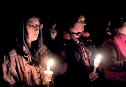Sherissa McLaughlin, left, of Moscow and her mother Sherry, center, attend a candlelight vigil for Sherissa’s friend Jillian Jones in Bingham on Sunday. Jones, who was killed last week in Augusta, grew up in the area.