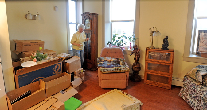 Madelaine Baum unpacks in her new fourth-floor apartment in the newly renovated Gerald Hotel in Fairfield.
