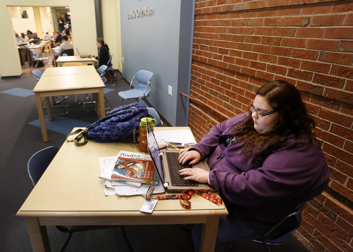 Harleyanne Hustus, a third-year student majoring in early childhood development, works on her laptop Thursday. She plans to get a bachelor’s from the University of Maine but came to SMCC first because it was less expensive. “Working and interning – it’s a lot,” she said.