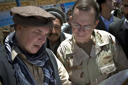 In this 2009 file photo released by Department of Defense, author Greg Mortenson (left) shows the locations of future village schools to U.S. Navy Adm. Mike Mullen, at the opening of Pushghar Village Girls School 60 miles north of Kabul in Panjshir Valley, Afghanistan.