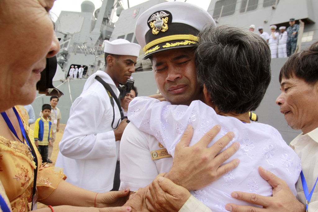 U.S. Navy commander Michael Vannak Khem Misiewicz emotionally embraces his aunt in 2010 in his native Cambodia, where he had been rescued as a child from the violence of the Khmer Rouge and adopted by an American. Now he’s accused of passing confidential information on Navy ship routes to a Singapore-based company in order to help facilitate a multimillion-dollar fraud scheme.