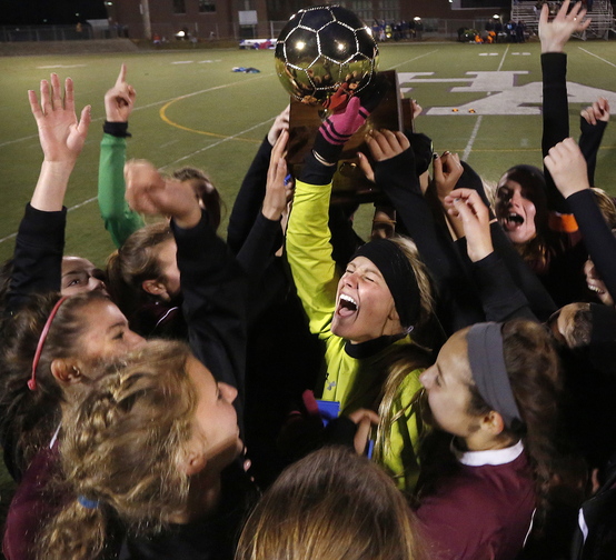 Keeper Mary Perkins, center, leads the celebration after Cape Elizabeth’s victory over Waterville in the Class B state championship game at Hampden.