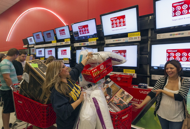 Roxanna Garcia, center, waits to pay for gifts at the Target store in Burbank, Calif., last November.