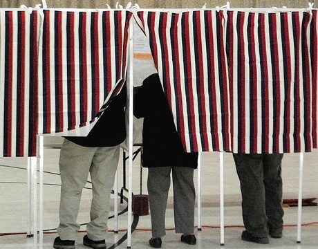 Voters fill in ballots in booths Tuesday at Augusta’s Ward 1 polling place in the Augusta Armory.