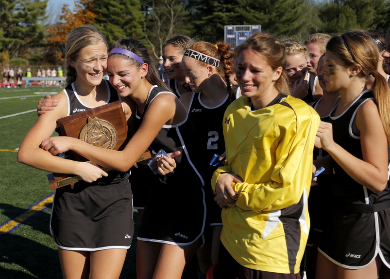 Skowhegan’s Mikayla Toh, left, receives a hug from Rylie Blanchet, as the Indians celebrate their win over Scarborough in the Class A field hockey championship at Yarmouth High School Saturday, November 2, 2013.