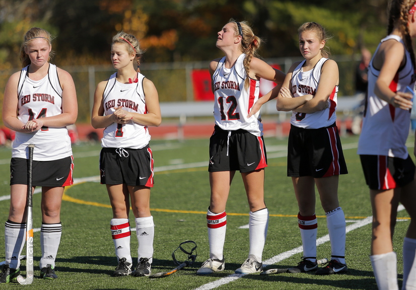 Scarborough field hockey players, left to right, Erin Brady, Mikaela Coombs, Maddy Dobecki, and Rachael Wallace had a hard time watching as they received the runners up trophies after losing the Class A field hockey championship to Skowhegan at Yarmouth High School Saturday, November 2, 2013.