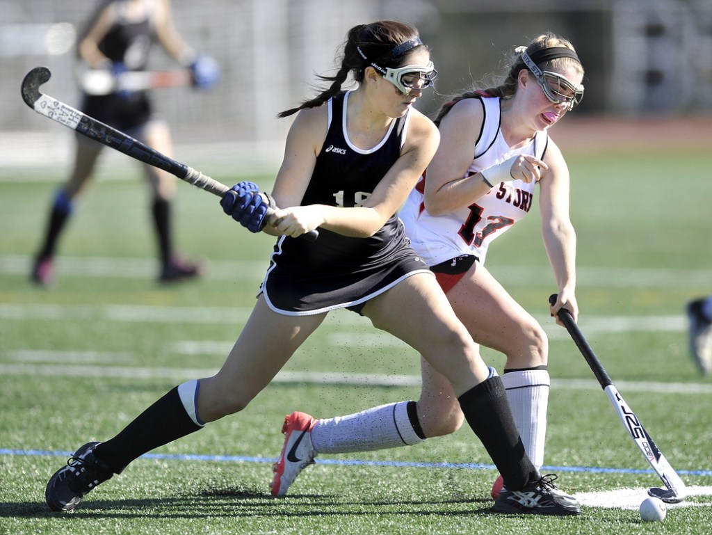 Skowhegan’s Haley Thebarge competes with Scarborough’s Maggie Carbin for control of the ball in second half action during the Class A field hockey championship at Yarmouth High School Saturday, November 2, 2013.