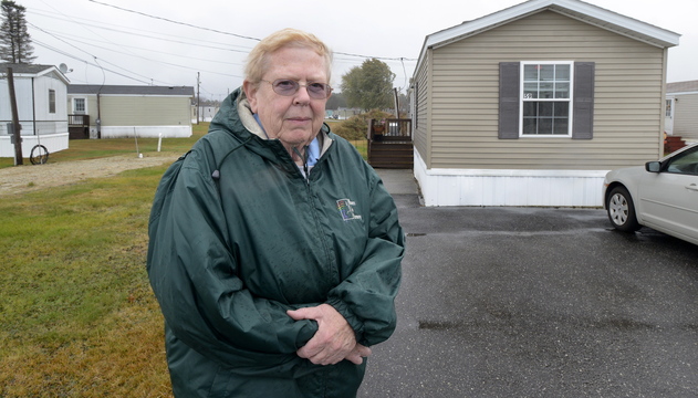 Sharon Brown, standing outside her mobile home in Brunswick, saw her property tax bill increase 12.6 percent this year. She is among about a dozen mobile home owners who have questioned their assessments.