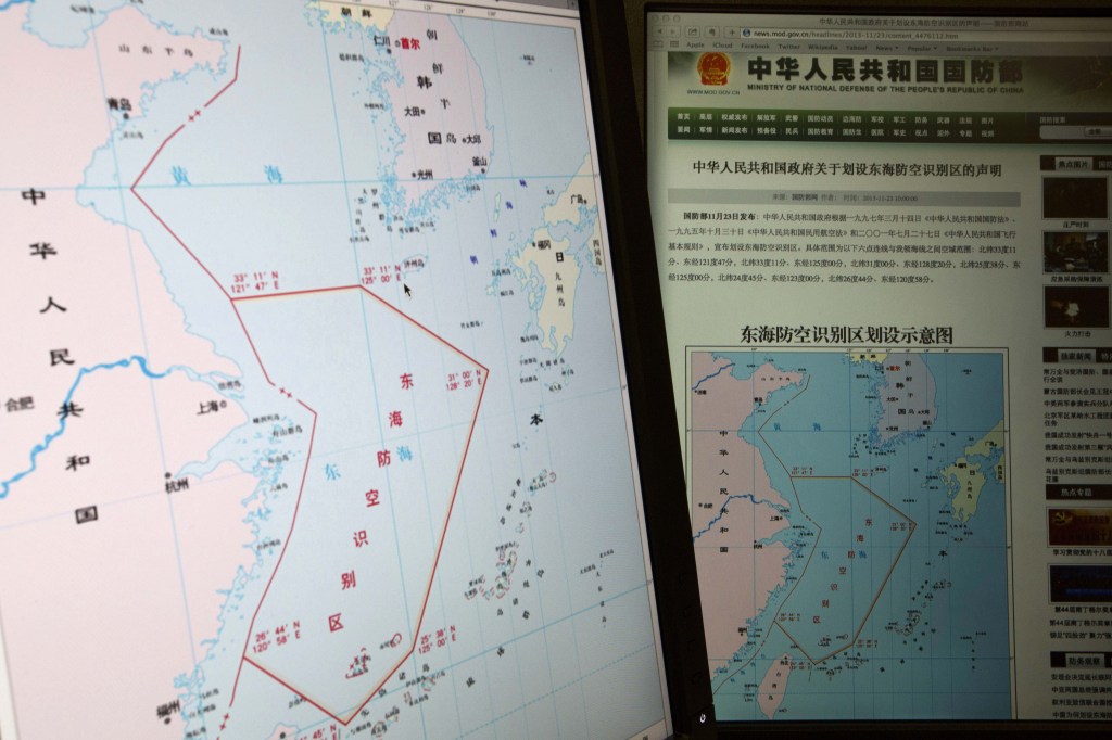 Computer screens display a map showing the red outline of China’s new air defense zone in the East China Sea on the website of the Chinese Ministry of Defense. Beijing said all aircraft entering the area must notify Chinese authorities and are subject to emergency military measures if they do not identify themselves or obey Beijing’s orders.