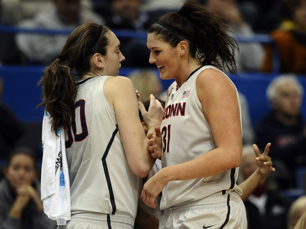 Connecticut’s Stefanie Dolson, right, is greeted by teammate Breanna Stewart after finishing a play during the Huskies’ rout over Oregon on Wednesday.