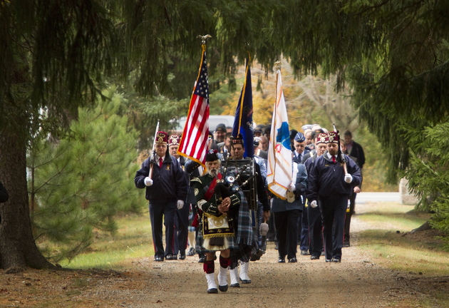 A piper leads the color guard into Pine Grove Cemetery before the second annual Veterans Day observance in West Kennebunk on Sunday.