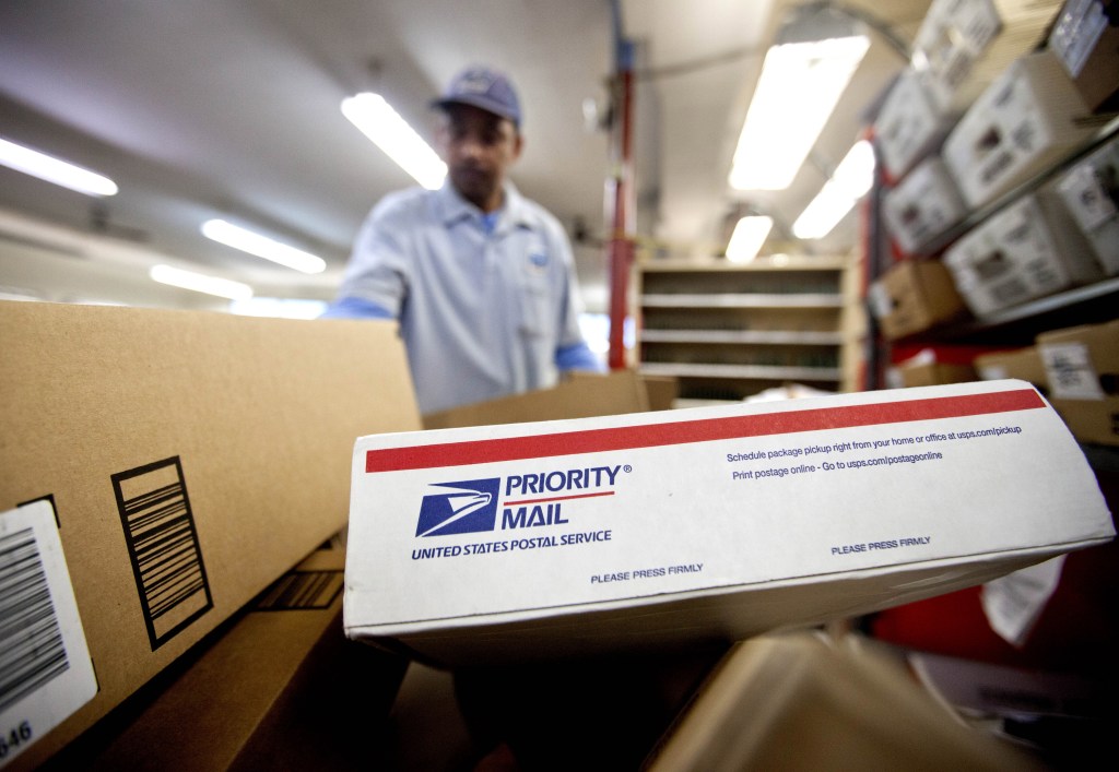 This Feb. 7, 2013 file photo shows packages waiting to be sorted in a Post Office in Atlanta. The U.S. Postal Service said Friday it lost $5 billion over the past year, and postal officials again urged Congress to pass legislation to help the beleaguered agency solve its financial woes.