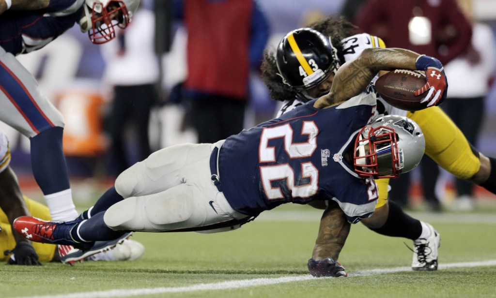 New England Patriots running back Stevan Ridley (22) scores a touchdown in front of Pittsburgh Steelers strong safety Troy Polamalu (43) in the fourth quarter of an NFL football game Sunday, Nov. 3, 2013, in Foxborough, Mass.