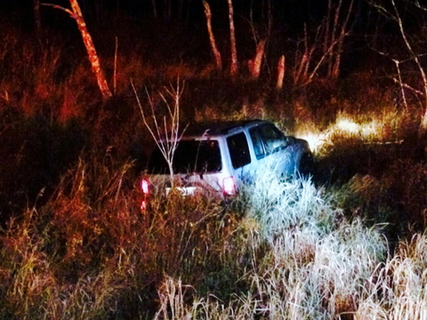 A 2001 Ford Explorer rests in a swamp off Carl Broggi Highway (Route 1 02) about a mile west of Little River Road in Lebanon Monday night. The driver escaped unharmed.