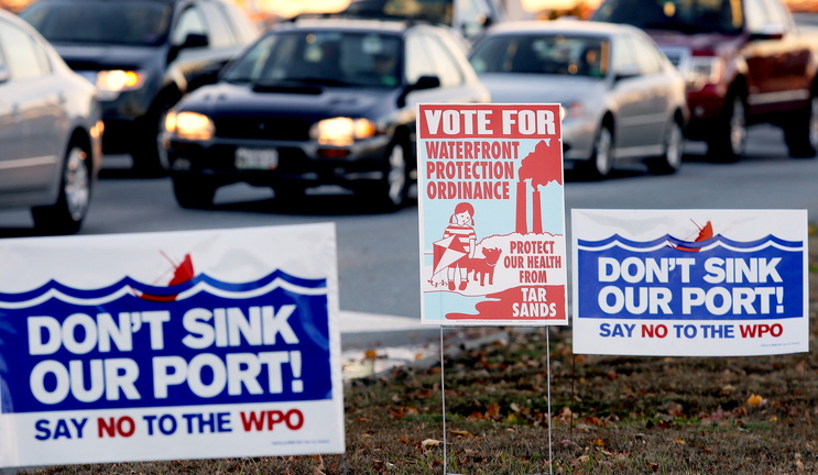 Campaign signs for and against a proposed waterfront ordinance in South Portland dot the median near the Casco Bay Bridge on Monday, a day before the election.