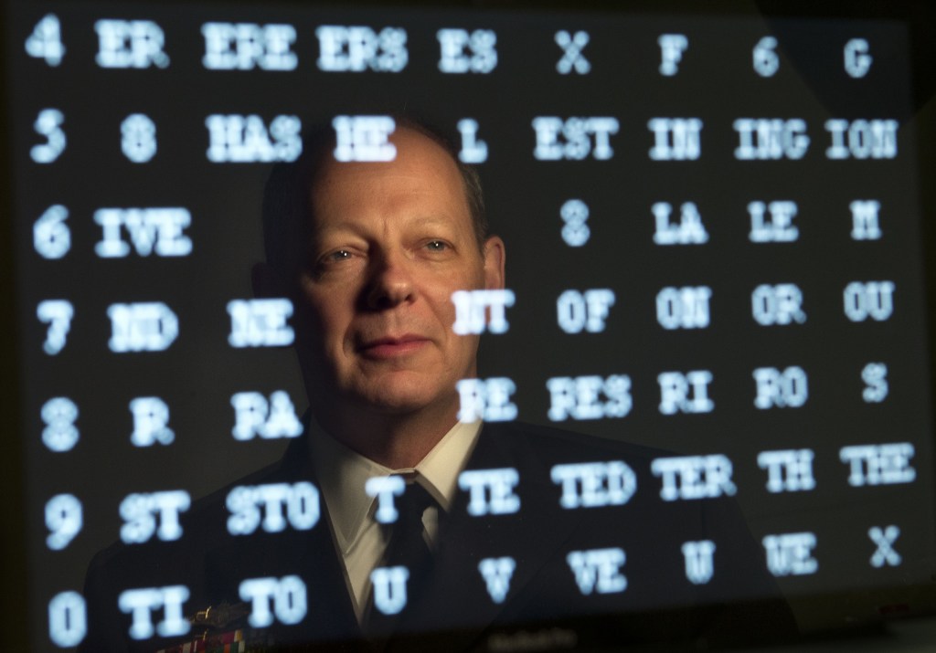 Rear Admiral William E. Leigher, reflected in a computer screen, is a Maine native who is one of the Navy’s top cybersecurity officials.