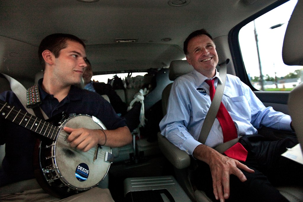 In a Sept. 25, 2009 photo, Democratic gubernatorial candidate Creigh Deeds spends time with his son Gus, left, on the road to Halifax, Va., between campaign events. Virginia State Police confirmed Tuesday, Nov. 19, 2013 that Creigh Deeds was stabbed multiple times and his son Gus, 24, was shot and killed at Deeds’ Home in Bath County, Va., during a Tuesday morning assault.