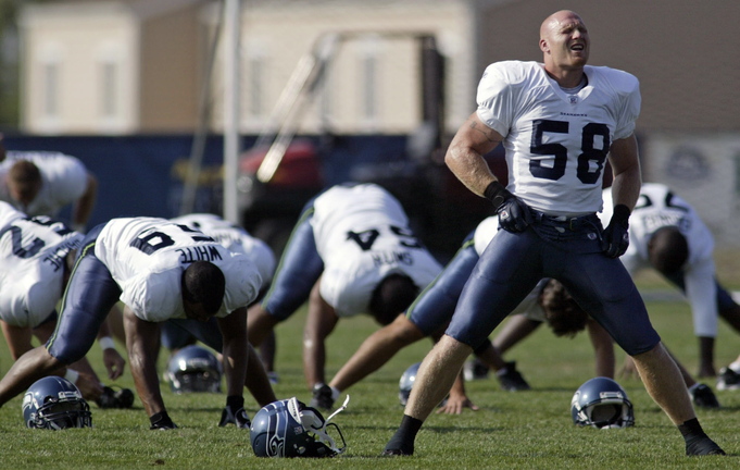 Seattle Seahawks linebacker Isaiah Kacyvenski (58) stretches during warmups at training camp in Cheney, Wash., in 2005. The Harvard-educated Kacyvenski said he isn’t surprised by recent allegations of teammates harassing others in the NFL.