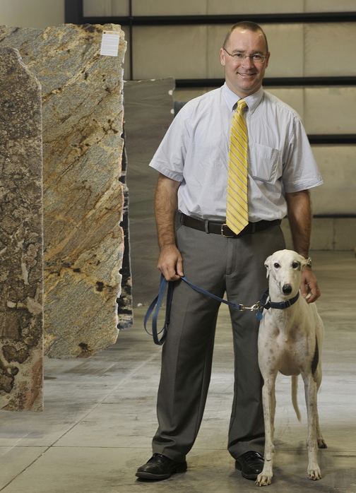 Matt Qualey, shown with his rescue dog Baron, is expanding his granite supply business to the Pine Tree Industrial Park in Portland. Qualey was named Maine Small Business Person of the Year.