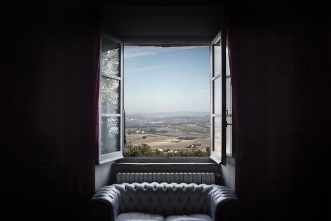 A view of the central Italian countryside from one of the windows of Villa La Montagnola in Umbria, where guests can take part in the annual olive harvest.