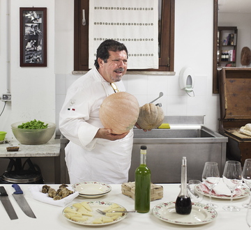 Singing chef Salvatore Denaro carries pumpkins during a cooking demonstration in the kitchen of the Arnaldo Caprai estate in Montefalco.