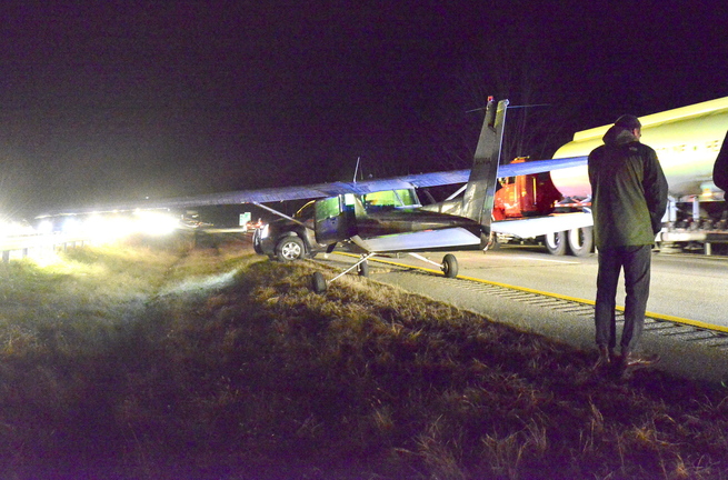 Sachin Hejaji of Falmouth talks on his phone after landing a Cessna 152 in the southbound lanes of Interstate 295 in Cumberland on Thursday evening. Drivers who saw the plane gliding low apparently slowed down, creating a gap in which he landed safely.