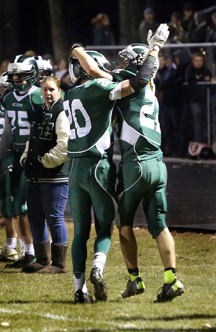 Ben Malloy, left, and Jon Woods of Bonny Eagle celebrate Friday night after Woods dove into the end zone for the only score of the first half against Thornton Academy.