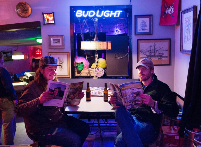 It’s almost showtime in Chapel Hill, N.C., and the Mallett Brothers Band’s Nick Leen, left, and Will Mallett read Southern Living magazine before going on stage near the end of a grueling six-week tour.