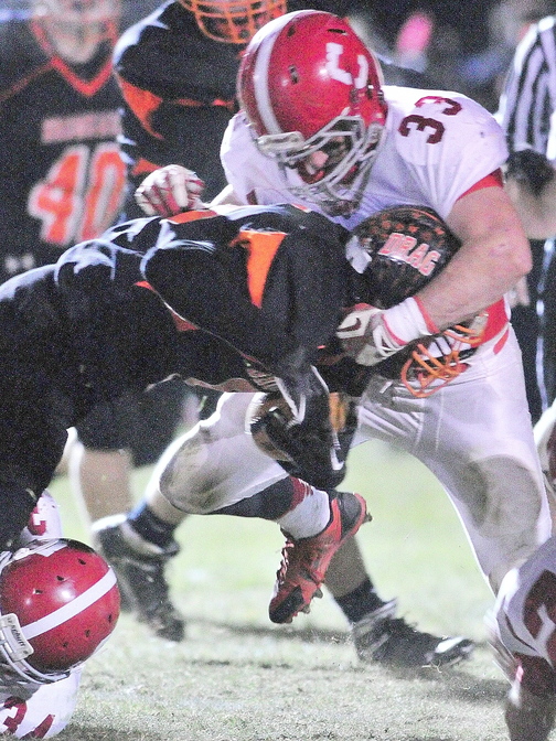 Cony Ram Reid Shostak (33) makes a tackle during the Pine Tree Conference class B championship against Brunswick on Friday in Brunswick.