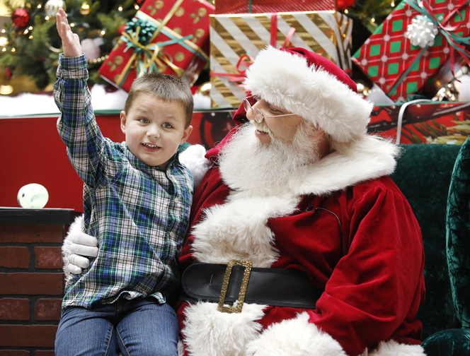 AJ Sweet, 4, of Windham meets Caring Claus on Sunday, during a special time for children with autism at the Maine Mall.